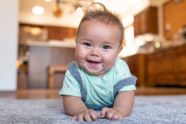 Baby laying on carpet flooring | Brooks Flooring Services Inc